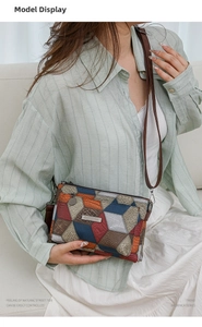 Detail of color-block patchwork tote with lychee and snake patterns and metal logo
