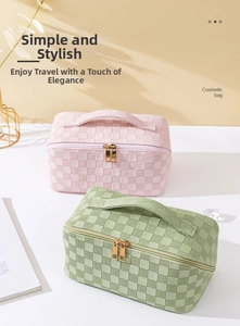 Close-up of woven checkerboard cosmetic bags in soft pink and green with a zipper closure