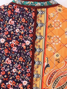 Detailed close-up of vintage patchwork quilted cotton fabric with floral and paisley patterns