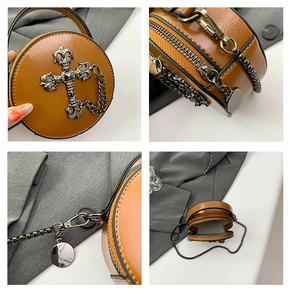 Macro details of brown leather crossbody bag with vintage silver cross and chain