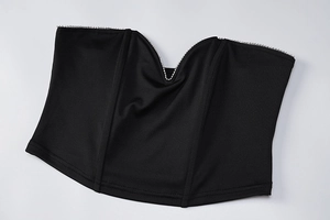 Detail of black strapless top featuring V-cut neckline with sparkling rhinestone trim