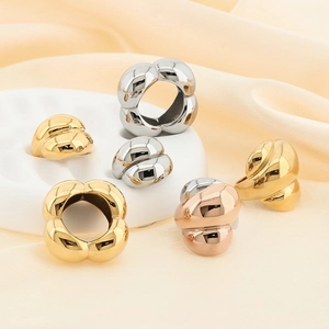 Chunky croissant dome rings in gold, silver, and rose gold finishes on elegant stands