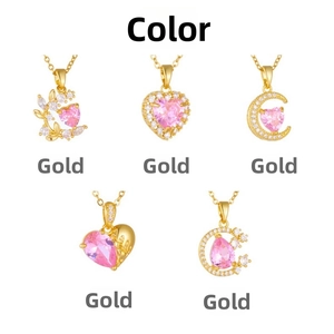 Detail view of five gold-plated necklaces with pink heart-shaped zircon pendants