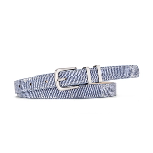 Detail of blue denim women belt with pearl buckle and white speckled pattern on white surface
