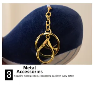 Close-up of high-quality gold metal lobster clasp and ring on whale plush charm