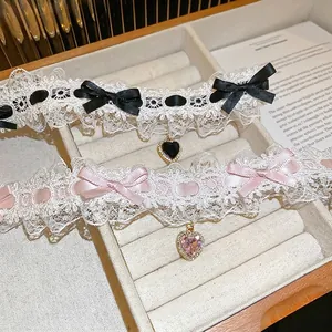 Elegant lace choker with satin bow and heart zircon pendant in a soft velvet jewelry box