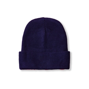 Close-up of deep purple knit beanie showing fine ribbed texture and wide folded cuff