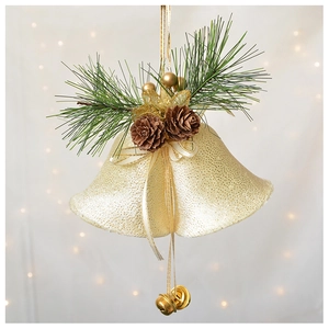Close-up of golden Christmas bells with pine needles, cones and glitter ornaments