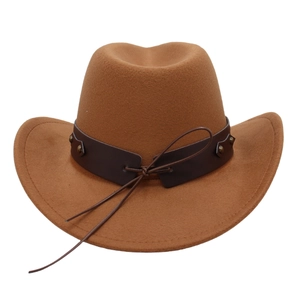 Close-up of brown felt cowboy hat with leather band and metal studs on white background