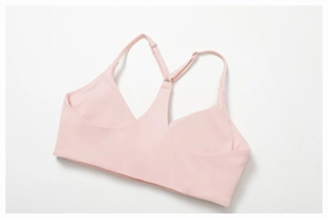 Close-up of adjustable thin straps and Y-shaped back design on light pink yoga bra