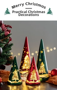 Close-up of conical glass Christmas lights with golden reindeer and tree patterns