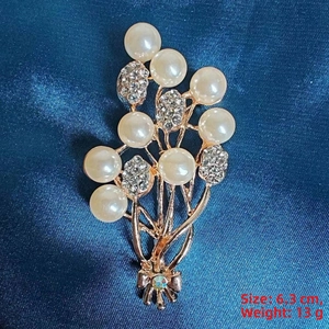 Detailed view of camellia brooch with cream pearls and dimensions 6.3cm, 13g weight