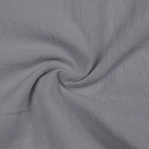 Close-up of grey linen cotton fabric texture with soft folds and breathable weave details