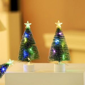 Macro detail of mini LED Christmas pine trees with colorful lights and star toppers
