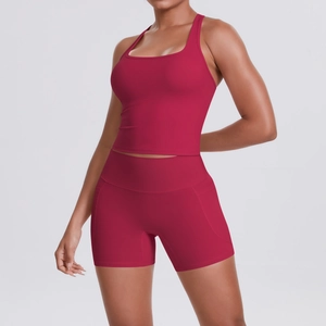 Detail view of high-waist sports shorts with functional side pocket in deep rose red