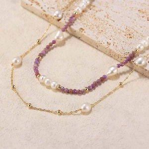 Macro detail of double-layer necklace with white pearls and purple natural stone beads