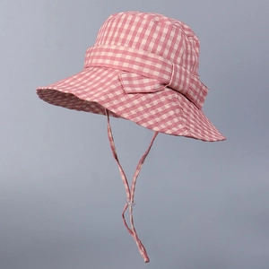 Detail of pink gingham bucket hat featuring a bow and adjustable windproof strap cord