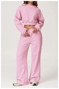 Detailed view of high-waisted pink sweatpants and cropped hoodie set with soft texture