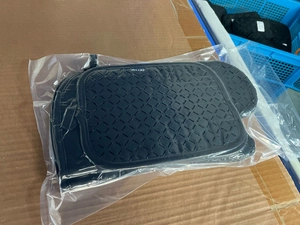 Macro view of heat-resistant silicone oven mitts in packaging with non-slip texture