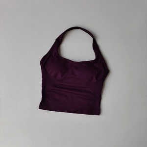 Close-up of deep purple halter sports bra with anti-slip texture and elastic hem