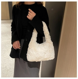 Plush white faux fur shoulder bag worn with a casual outfit to show size and texture