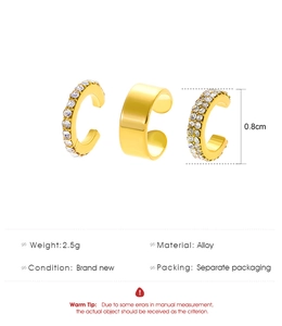 Detailed view of three-piece gold alloy ear cuff set with cubic zirconia and smooth finish