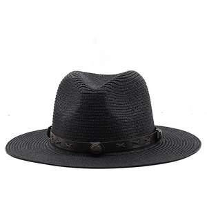 Detail of black straw fedora showing high-quality weave texture and brown leather band