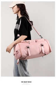 Detailed side view of pink sports bag featuring a dedicated shoe compartment and shoulder strap