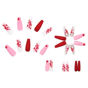 Red heart press-on nails in long coffin shape with glittering rhinestone accents