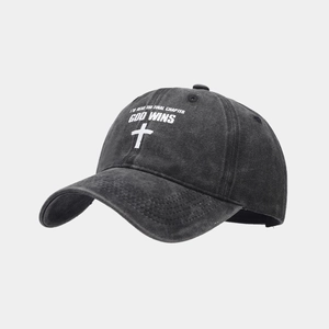 Detailed macro view of charcoal washed canvas texture and religious cross print on cap