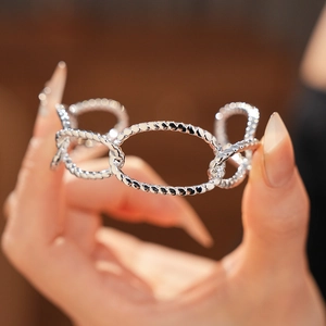 Macro shot of silver twisted rope oval link bracelet with high polish mirror finish
