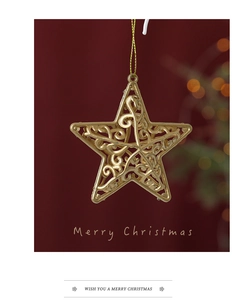 Close-up of golden hollow star ornament for Christmas tree decoration with Merry Christmas text