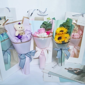 Detailed soap flower bouquets with cute teddy bears in premium gift bags for graduation