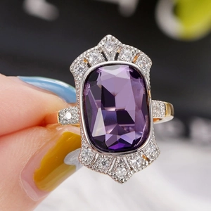 Detailed macro view of vintage court style ring with a large rectangular purple gemstone