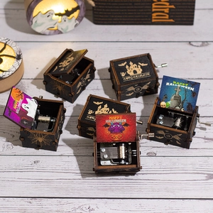 Hand-cranked wooden Halloween music box featuring pumpkin and ghost theme designs