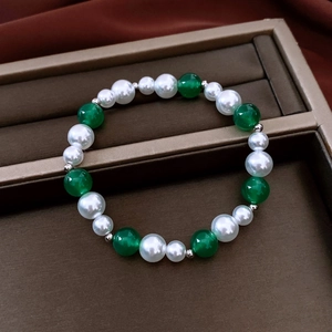 Detail of vintage pearl and green agate beaded bracelet in a brown jewelry gift box