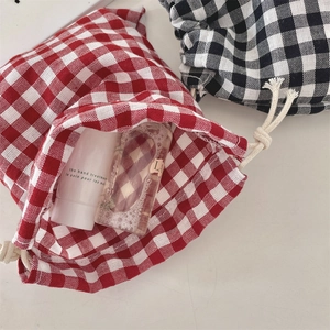 Detail of red and black checkered drawstring pouches for cosmetics and small accessories