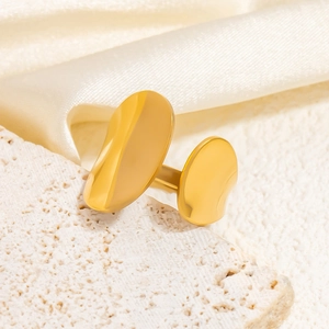 Macro shot of gold 18k plated irregular chunky ring on luxury silk and stone background