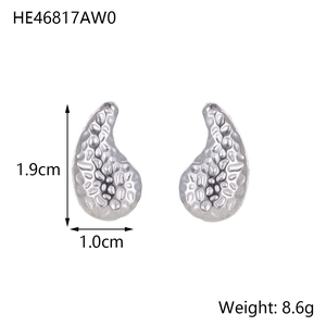 Macro view of silver teardrop titanium earrings with unique hammered texture and dimensions