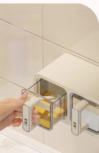 Detail of wall-mounted cream seasoning box with drawer handle and integrated spoon