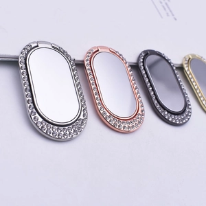 Close-up of four luxury oval metal phone ring holders with rhinestones and mirrors