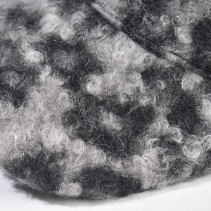Macro view of curly lambswool texture on checkered baseball cap in grey mix