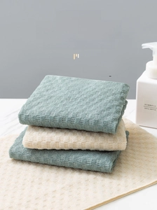 Close-up of honeycomb texture exfoliating back scrubber towels on marble surface