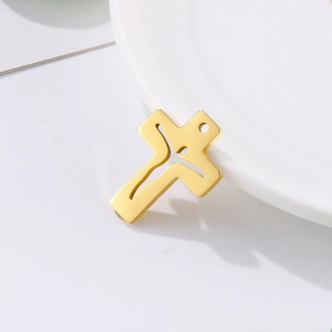 Polished gold stainless steel hollow cross pendant on a minimalist white background