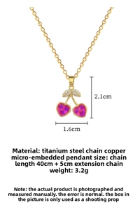 Detail view of gold titanium cherry pendant set with pink gems and white zircons