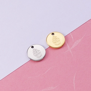 Macro shot of gold and silver ice cream pendants made of polished 18K titanium steel