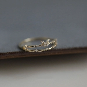 Macro shot of double-layer butterfly ring with gold plating and sparkling zircon stones
