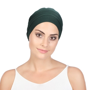 Detailed view of the pleated design on dark green turban hat for women's hair care