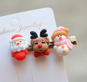 Detail of Christmas hair clip featuring Santa Claus, reindeer, and snowman figurines