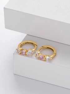 Detailed close-up of 925 silver gold hoop earrings with pink heart-shaped zircons